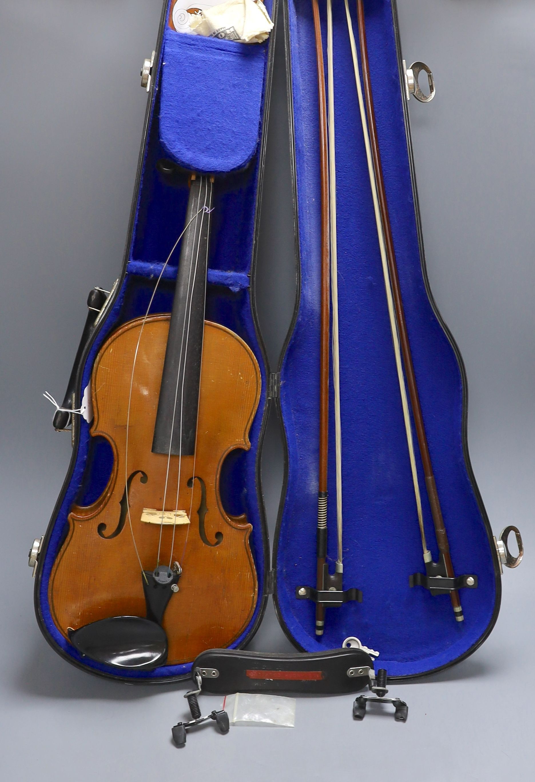 A 20th century violin in case with two bows, length of back 35.5cm
